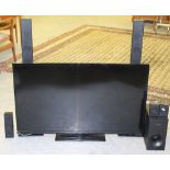 A DigiHome 50" flatscreen television together with a Samsung surround sound speaker system, used