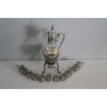 A silver plate and glass coffee carafe and warming stand 41cm and 12 glass cans with embossed and