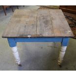 A Victorian painted pine kitchen table with turned legs on castors 76cm x 98.5cm barn stored