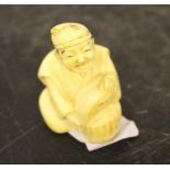 A small Japanese carved ivory netsuke, seated gentleman, 4.5cm head damaged.