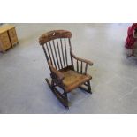 A 19th century bobbin-turned rocking chair, turned spindles, shaped arms and seat, 104cm replacement