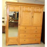 A Victorian Gregory & Co ash mirror door wardrobe, the moulded cornice with geometric carving over a