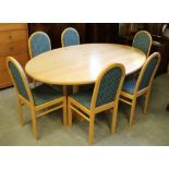 A large modern lightwood oval dining table with refectory style base 85cm x 188cm x 128cm and six