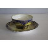 A continental Viersa porcelain cabinet cup and saucer, the cup decorated with a mill, with cobalt