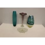 Three modern coloured art glass vases and a clear glass cake stand, each in good condition.