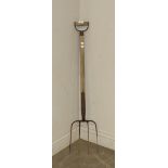 A vintage four tine pitch or manure fork, 108cm weathered, wear to handle, a degree of corrosion