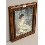 A holographic /lenticular print, young woman relaxing by a waterwheel, walnut effect moulded frame