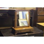 A 19th century mahogany swing toilet mirror, the rectangular plate between slender finial topped