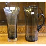 A Whitefriars smoked glass lemonade jug 26cm and a modern flared cylindrical glass vase 24cm in good