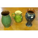 Two Wetheriggs Pottery vases 22cm & 24.5cm together with a Wetheriggs Pottery jug, with some spout