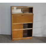 A mid century Minty oak sectional secretaire/bureau bookcase, the upper section with sliding glass