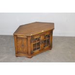 An oak television cabinet, in the 17th century style 50cm x 99cm x 51cm some scratching to top