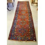 A Persian runner, with a row of central medallions enclosed by borders 340cm x 104cm some wear and