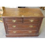 An Edwardian oak chest of drawers, two short and two long drawers, with shaped brass back plates and
