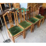A set of four Arts & Crafts oak dining chairs, with yoke-form top-rails and carved and pierced spat,