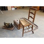 An Edwardian rush-seated ladder back chair, Jones sewing machine and a leather and wood swingle