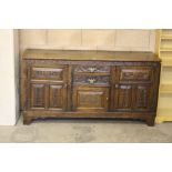 A Georgian oak dresser base, the rectangular top above two central drawers with panelled door