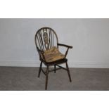 A stained elm Wheelback Windsor armchair of Ercol style (stamped Made in England to base), and a