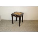 An imported hardwood games table, with chequer board top over a single frieze drawer containing