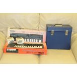 Two vintage Yamaha PSS130 keyboards, a selection of LP records, 8-track player and cassettes.