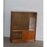 A 1970's glazed teak bookcase by Herbert E Gibb, sliding glass doors over sliding solid doors, 112.