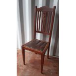 An Edwardian walnut bedroom/dining chair of Art Nouveau design, studded brown vinyl seat