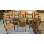 A matched set of eight G-Plan teak dining chairs, four with vinyl seats four material, label to