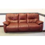 An oxblood coloured leather three seater settee 225cm