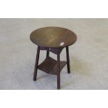 An Arts & Crafts oak occasional table, with circular top over four angled square section legs with