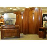 A 1960's walnut four piece bedroom suite, comprising a large wardrobe, small wardrobe, dressing