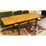 An oak extending kitchen table, the rectangular top and two additional leaves on square section legs