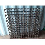 An 144 bottle metal and pine wine rack, 120cm square x 20cm deep, slightly dented and rusted