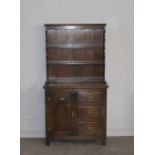 A small panelled oak dresser of 18th Century style by Reprodux, 92cm wide x 42cm deep x 172cm