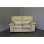 A small two-seater cream leather settee, originally purchased from Chapman's 155cm good condition,