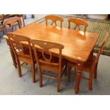 A modern stained hardwood kitchen table with turned barley-twist style legs, 76cm x 152cm x 91cm