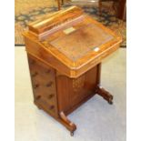 A late Victorian inlaid walnut davenport, with domed and hinged oblong stationary compartment over