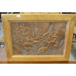 A 1970's copper panel, embossed with poppies and wheat, within a broad light oak frame, 46cm x
