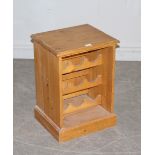 A small pine wine storage cupboard to hold twelve bottles, 43cm x 36cm x 60cm high, damaged top