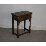 A 'aged' oak side or hall table of 18th Century style, fitted single drawer on turned legs with