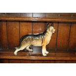 A large vintage pottery Alsatian figure, unmarked 30cm x 38cm in good condition.
