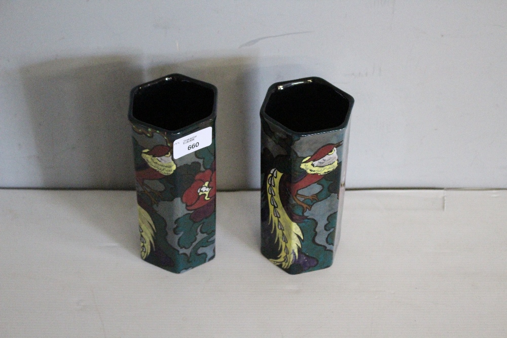 A Pair of hexagonal Decoro pottery vases, decorated with a peacock design, 17.5cm one cracked.