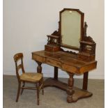 A Victorian figured walnut Duchess dressing table, with architectural mirror between carved and