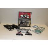 A selection of die-cast model cars and motorcycles, including Maisto, two with display cases, some