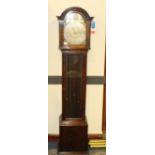 A 1930's three train oak long cased clock, having a moulded arched hood with glazed door enclosing