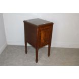 An Edwardian mahogany pot cupboard, with banded and panelled door and tapering square section legs