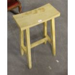 A modern light oak stool, with curved oblong top 76cm minor marks and scratches.