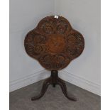 A 19th century oak snap-top stem table, the lobed top carved with fluted C-scrolls over the snap-top