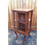 Edwardian mahogany square revolving bookcase, inlaid with chequered banding, on cabriole legs,