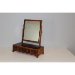 A 19th century strung-mahogany toilet mirror, the rectangular plate between slender supports and