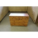 An Alstons rustic pine effect seven drawer chest, with bun style feet 81cm x 116cm x 41cm good